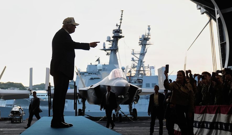 President Donald Trump gestures as he walks towards the stage before speaking to members of the military aboard the USS George Washington, an aircraft carrier docked at an American naval base, in Yokosuka, Tuesday, Oct. 28, 2025. (AP Photo/Mark Schiefelbein)
