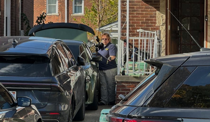 FBI agents gather outside a home in a Dearborn, Mich., neighborhood on Friday, Oct. 31, 2025. (AP Photo/Mike Householder) ** FILE **