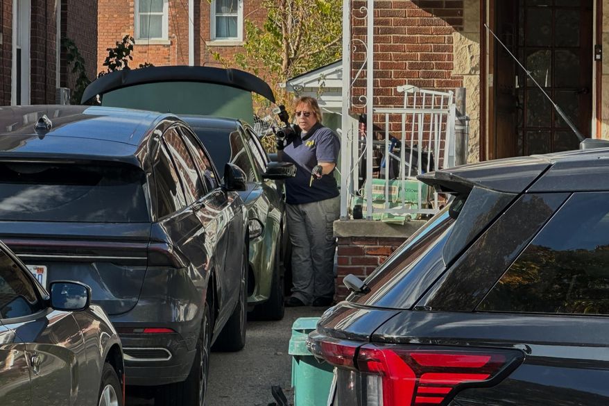 FBI agents gather outside a home in a Dearborn, Mich., neighborhood on Friday, Oct. 31, 2025. (AP Photo/Mike Householder) ** FILE **