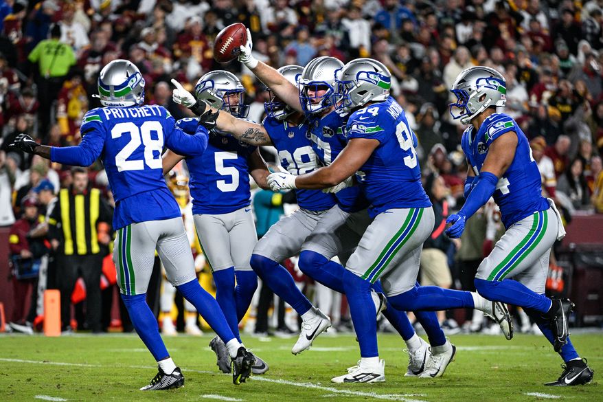 Seattle Seahawks linebacker Connor O’Toole (57) celebrates with teammates after recovering a fumble on a kick return by Washington Commanders receiver Jaylin Lane (83) at Northwest Stadium in Landover, Maryland, November 2, 2025. (Photo by Brian Murphy for the Washington Times)
