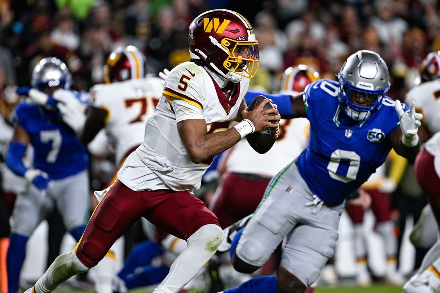 Washington Commanders quarterback Jayden Daniels (5) scrambles for an 8-yard gain during the second quarter against the Seattle Seahawks at Northwest Stadium in Landover, Maryland, November 2, 2025. (Photo by Brian Murphy for the Washington Times)