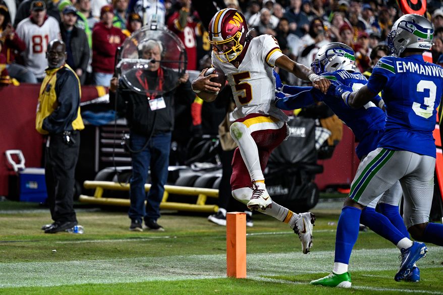 Washington Commanders quarterback Jayden Daniels (5) gets pushed out of bounds at the 1-yard line by Seattle Seahawks cornerback Devon Witherspoon (21) at Northwest Stadium in Landover, Maryland, November 2, 2025. (Photo by Brian Murphy for the Washington Times)