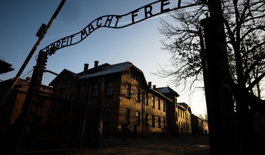 FILE - The sun lights the buildings behind the entrance of the former Nazi death camp Auschwitz-Birkenau in Oswiecim, Germany, Dec. 6, 2019. (Photo/Markus Schreiber, File)