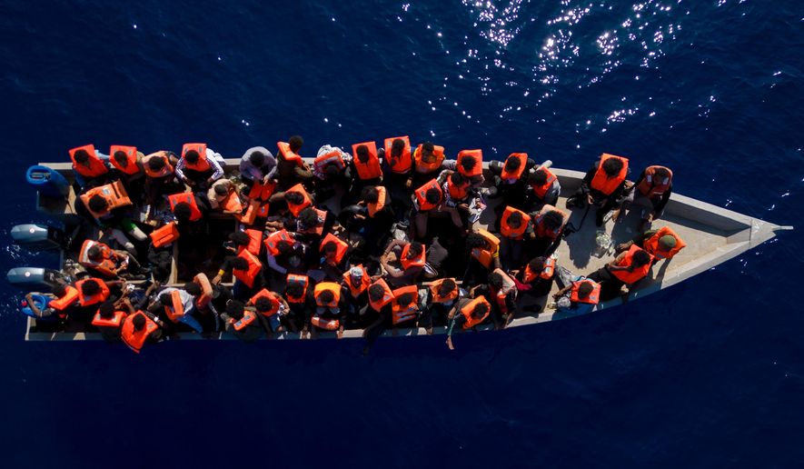 FILE - Migrants from Eritrea, Libya and Sudan sail a wooden boat before being assisted by aid workers of the Spanish NGO Open Arms, in the Mediterranean sea, about 30 miles north of Libya, Saturday, June 17, 2023. (AP Photo/Joan Mateu Parra, File)
