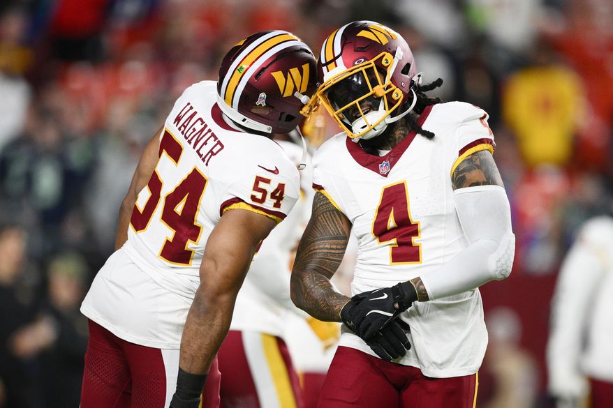 Washington Commanders linebacker Bobby Wagner (54) and linebacker Frankie Luvu (4) on the field before the start of of an NFL football game against the Seattle Seahawks, Sunday, Nov. 2, 2025, in Landover, Md. (AP Photo/Nick Wass)
