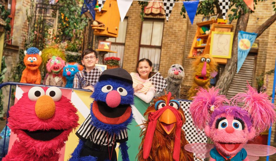 This image released by Sesame Workshop shows muppet characters Elmo, left, Grover, second left, and Abby, right, from the "Sesame Street" episode "Elmo Runs the Race." (Zach Hyman/Sesame Workshop via AP)
