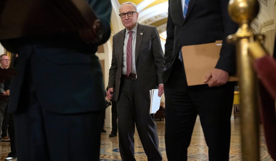 Senate Minority Leader Chuck Schumer, of N.Y., stands as his Senate colleagues speak with reporters following a closed-door meeting of Senate Democrats on Capitol Hill in Washington on Tuesday, Nov. 4, 2025. (AP Photo/Mark Schiefelbein) **FILE**