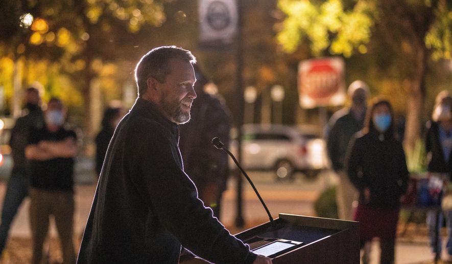 Bishop Steve Wood of St. Andrew's Church thanks health care workers at East Cooper Medical Center, where he was a patient fighting COVID-19 easier in the year, during an evening event to honor health care workers at East Cooper Medical Center, Monday, Dec. 14, 2020. (Grace Beahm Alford/The Post And Courier via AP) ** FILE **