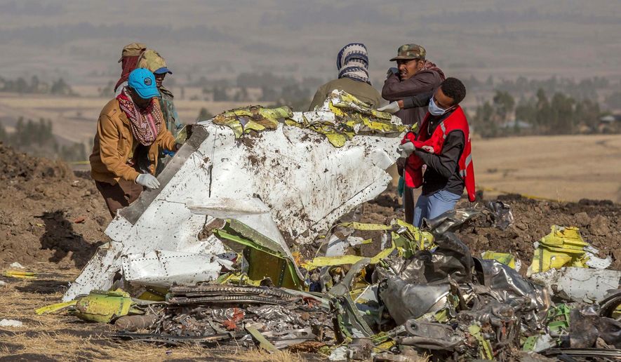 FILE - In this March 11, 2019, file photo, rescuers work at the scene of an Ethiopian Airlines flight crash near Bishoftu, Ethiopia. Pilot Bernd Kai von Hoesslin pleaded with his bosses for more training on the Boeing Max, just weeks before the Ethiopian Airline's jet crashed, killing everyone on board. (AP Photo/Mulugeta Ayene, File)