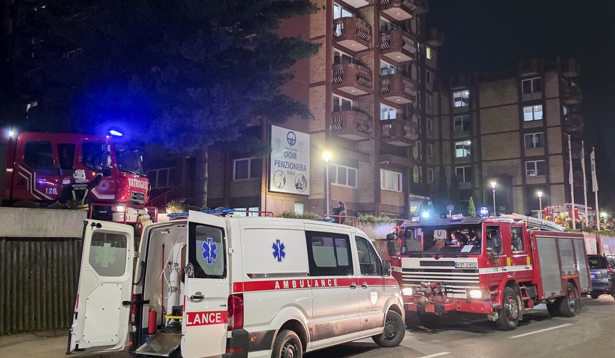 A rescue cars are parked in front of a nursing home after a fire in Tuzla, Bosnia, Tuesday, Nov. 4, 2025. (AP Photo)