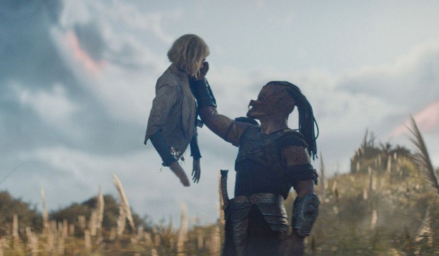 This image released by 20th Century Studios shows Thia, portrayed by Elle Fanning, left, and Dek, portrayed by Dimitrius Schuster-Koloamatangi, in a scene from "Predator: Badlands." (20th Century Studios/Disney via AP)