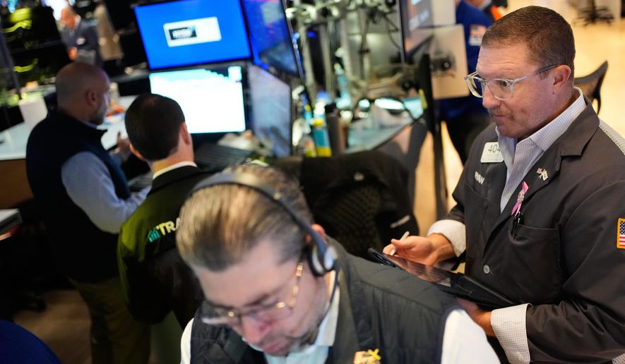 Ryan Falvey, right, works on the floor at the New York Stock Exchange in New York, Wednesday, Oct. 29, 2025. (AP Photo/Seth Wenig)