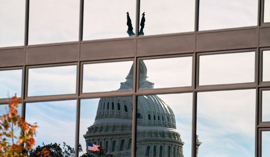 The Capitol dome is distorted by windows on the teamster's building, Tuesday, Nov. 4, 2025, in Washington. (AP Photo/Allison Robbert)
