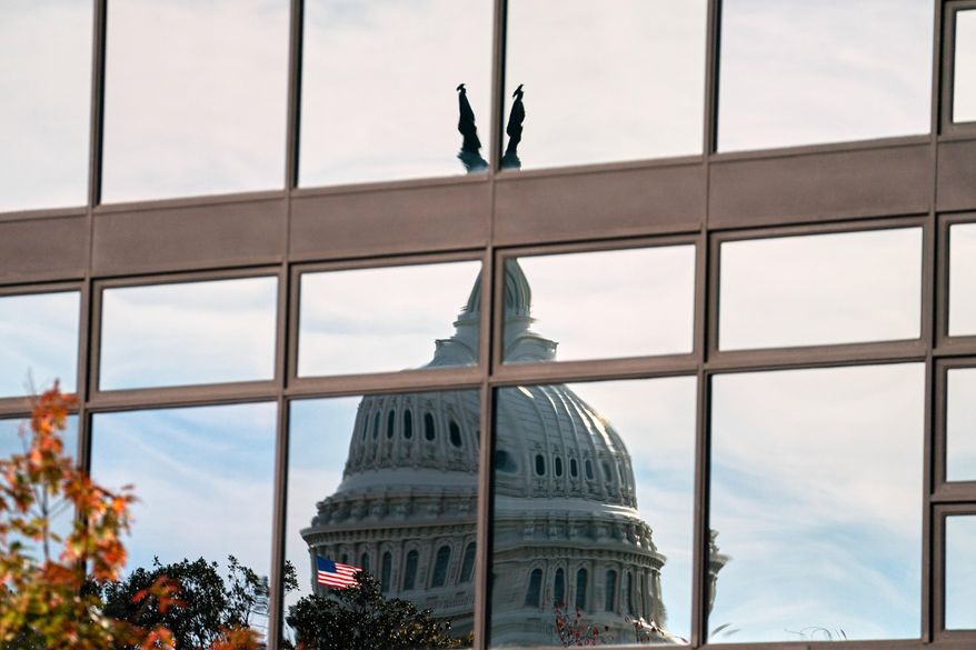 The Capitol dome is distorted by windows on the teamster's building, Tuesday, Nov. 4, 2025, in Washington. (AP Photo/Allison Robbert)