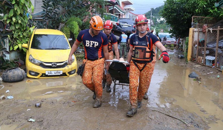 Rescue workers carry an injured resident as Typhoon Kalmaegi affects Cebu city, central Philippines on Tuesday, Nov. 4, 2025. (AP Photo/Jacqueline Hernandez)
