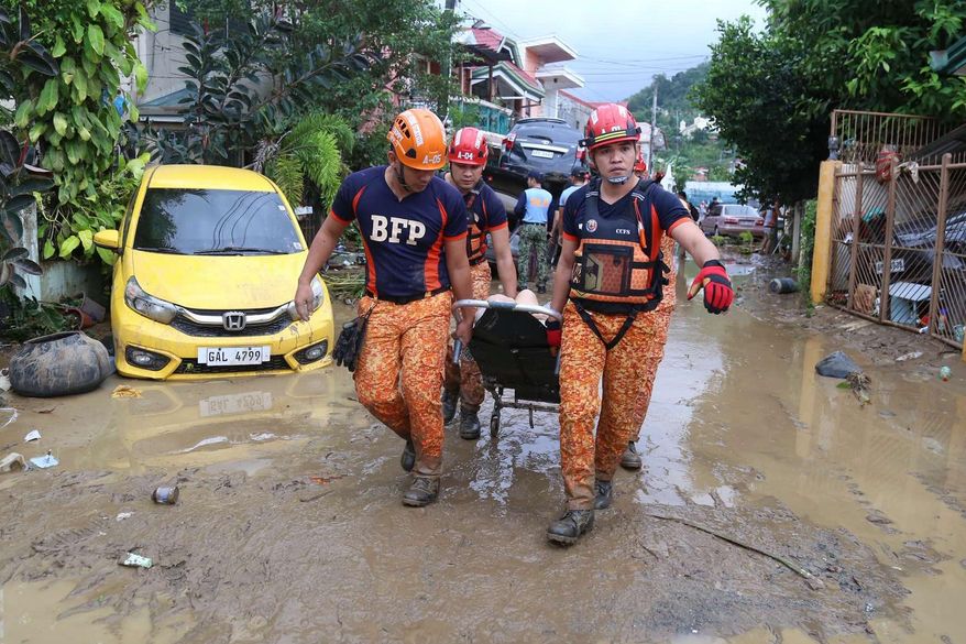 Rescue workers carry an injured resident as Typhoon Kalmaegi affects Cebu city, central Philippines on Tuesday, Nov. 4, 2025. (AP Photo/Jacqueline Hernandez)