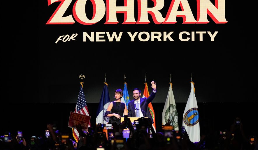 Mayor-elect Zohran Mamdani, right, and his wife Rama Duwaji react to supporters during an election night watch party, Tuesday, Nov. 4, 2025, in New York. (AP Photo/Yuki Iwamura)
