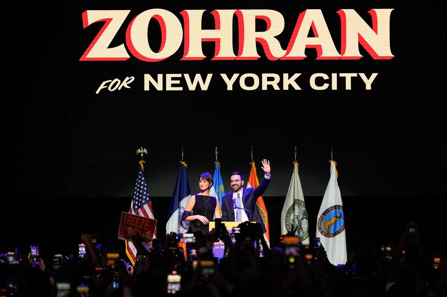 Mayor-elect Zohran Mamdani, right, and his wife Rama Duwaji react to supporters during an election night watch party, Tuesday, Nov. 4, 2025, in New York. (AP Photo/Yuki Iwamura)