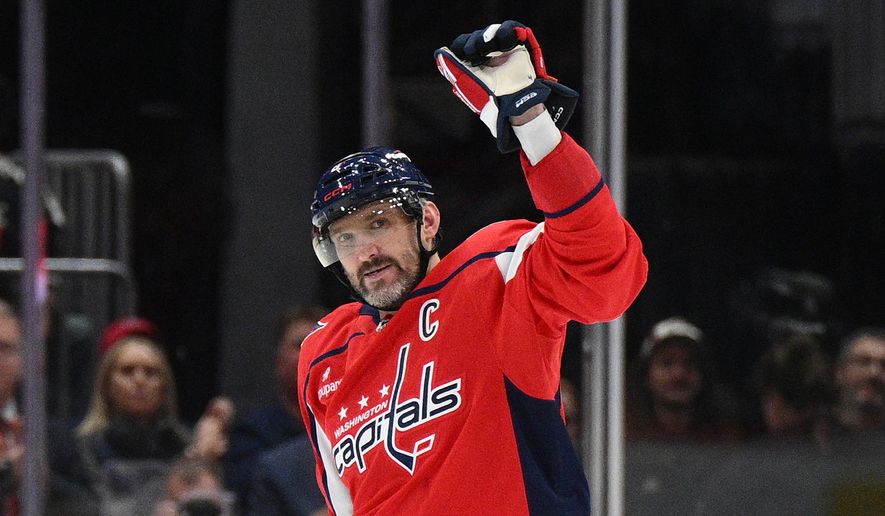 Washington Capitals left wing Alex Ovechkin (8) celebrates his 900th career NHL goal during the second period of an NHL hockey game against the St. Louis Blues, Wednesday, Nov. 5, 2025, in Washington. (AP Photo/Nick Wass)