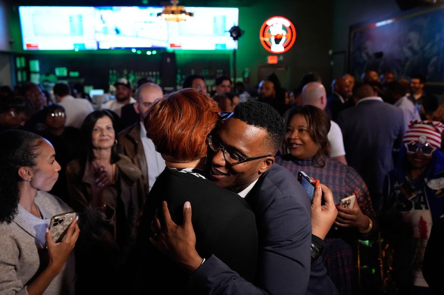 Democratic 18th Congressional District candidate Christian Menefee, right, hugs an attendee during an election night watch party on Tuesday, Nov. 4, 2025, in Houston. (AP Photo/Ashley Landis)