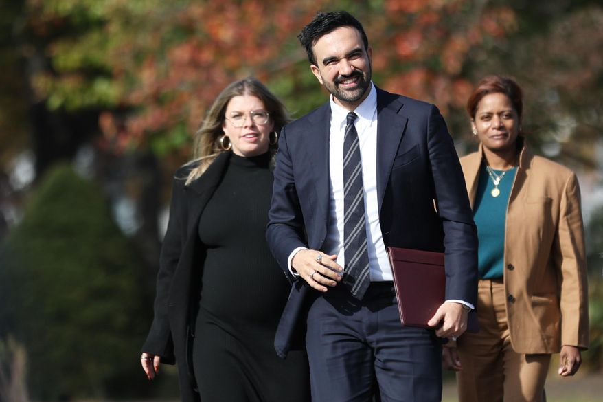 New York City mayor-elect Zohran Mamdani, center, walks with members of his transition team including Elana Leopold, left, and Melanie Hartzog for a news conference in the Queens borough of New York, Wednesday, Nov. 5, 2025. (AP Photo/Heather Khalifa)