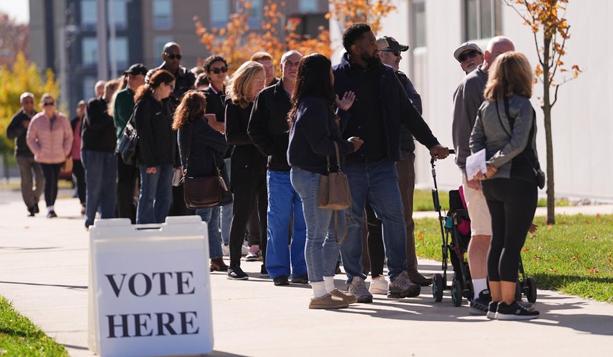 Voters wait in line to cast their ballot at a polling place at Rowan College in Mount Laurel, N.J., Monday, Oct. 27, 2025. (AP Photo/Matt Rourke) **FILE**