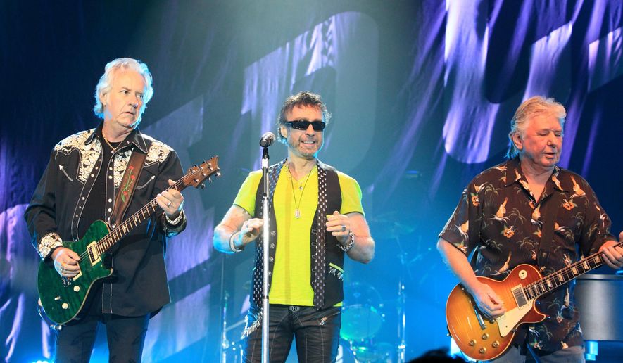 FILE - Howard Leese, from left, Paul Rodgers, and Mick Ralphs, of the classic rock band Bad Company, perform in Bethlehem, Pa., on July 29, 2013. (Photo by Owen Sweeney/Invision/AP, File)