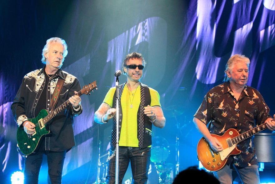 FILE - Howard Leese, from left, Paul Rodgers, and Mick Ralphs, of the classic rock band Bad Company, perform in Bethlehem, Pa., on July 29, 2013. (Photo by Owen Sweeney/Invision/AP, File)