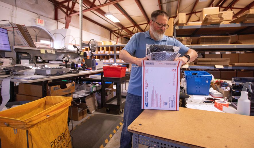 FILE - Terry Precision Cycling warehouse manager Luke Tremble packs orders at the company’s warehouse in Burlington, Vt., Tuesday, Oct. 28, 2025. (AP Photo/Amanda Swinhart, File)
