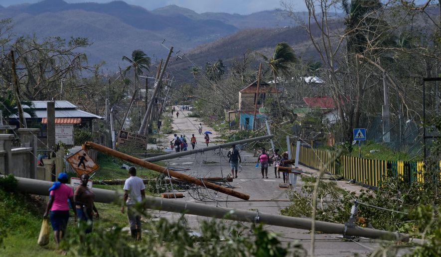 Residents walk through Lacovia Tombstone, Jamaica, in the aftermath of Hurricane Melissa, Wednesday, Oct. 29, 2025. (AP Photo/Matias Delacroix, File)