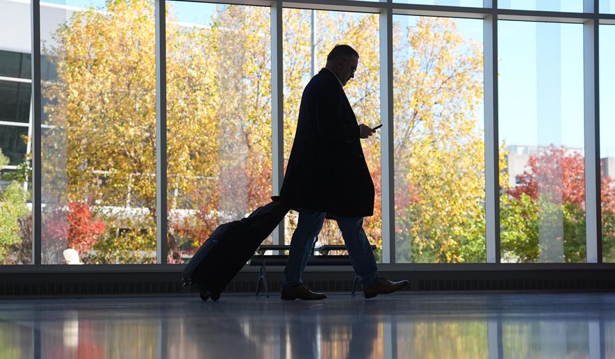 A traveler moves through a baggage claim in Philadelphia International Airport in Philadelphia, Wednesday, Nov. 5, 2025. (AP Photo/Matt Rourke)