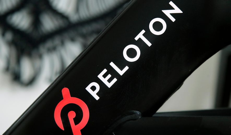 FILE - The Peloton logo is seen on the company's stationary bicycle in San Francisco, Calif., Nov. 19, 2019. (AP Photo/Jeff Chiu, File)
