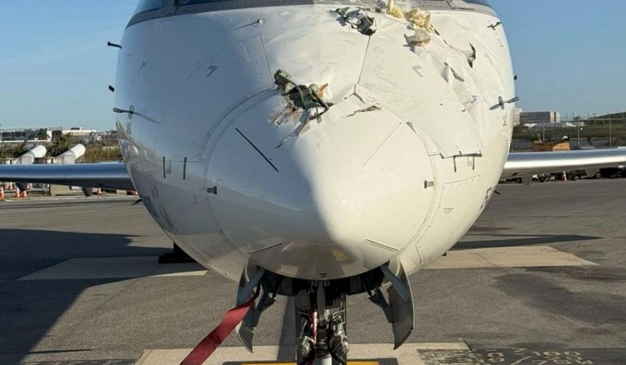 This undated photo provided by a National Transportation Safety Board report Thursday, Nov. 6, 2025, shows damage on the nose of Flight 5047 sustained during a collision with another aircraft at LaGuardia Airport in New York, Oct. 1, 2025. (National Transportation Safety Board via AP)