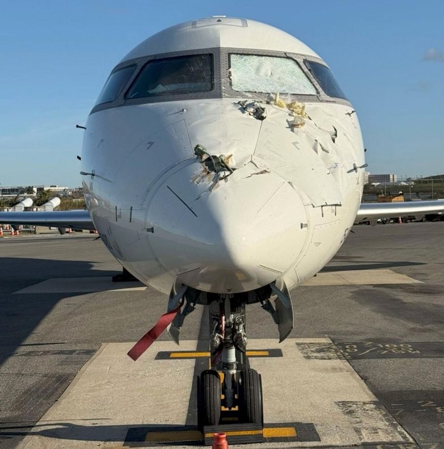 This undated photo provided by a National Transportation Safety Board report Thursday, Nov. 6, 2025, shows damage on the nose of Flight 5047 sustained during a collision with another aircraft at LaGuardia Airport in New York, Oct. 1, 2025. (National Transportation Safety Board via AP)