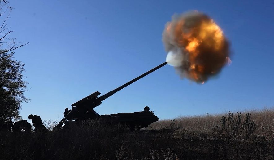 In this image, made from video and provided by Russian Defense Ministry Press Service on Thursday, Nov. 6, 2025, Russian soldiers fire a Malka self-propelled gun towards Ukrainian positions on an undisclosed location in Ukraine. (Russian Defense Ministry Press Service via AP)