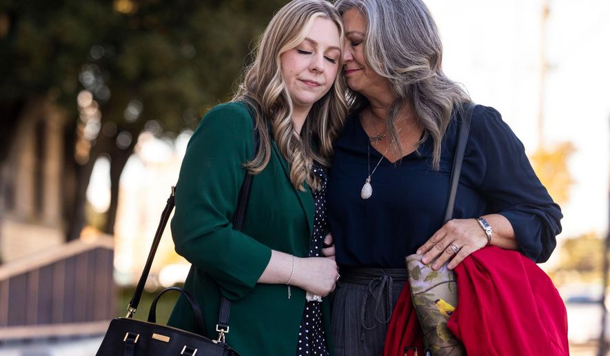 Abby Zwerner shares a moment with her mother Julie Zwerner after a verdict was reached in her lawsuit against the assistant principal, Ebony Parker, of Richneck Elementary School during proceedings at Newport News Circuit Court in Newport News, Va. on Thursday, Nov. 6, 2025. (Kendall Warner/The Virginian-Pilot via AP)