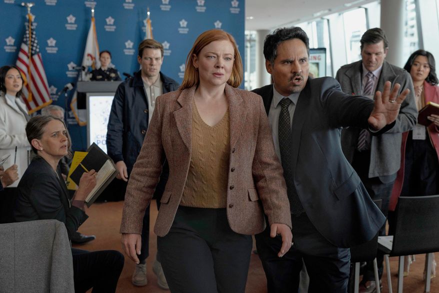 This image released by Peacock shows Sarah Snook, center, and Michael Peña, right, in a scene from "All Her Fault." (Sarah Enticknap/Peacock via AP)