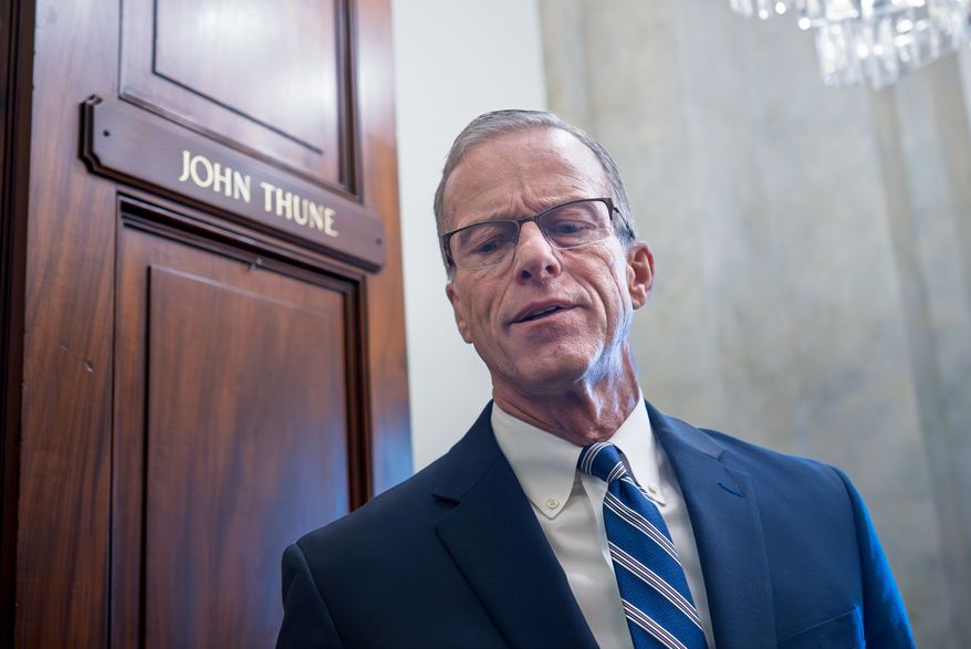 Senate Majority Leader John Thune, R-S.D., stands in the door of his office as he responds to reporters looking for updates on a plan to end the 38 day government shutdown, at the Capitol in Washington, Friday, Nov. 7, 2025. (AP Photo/J. Scott Applewhite)
