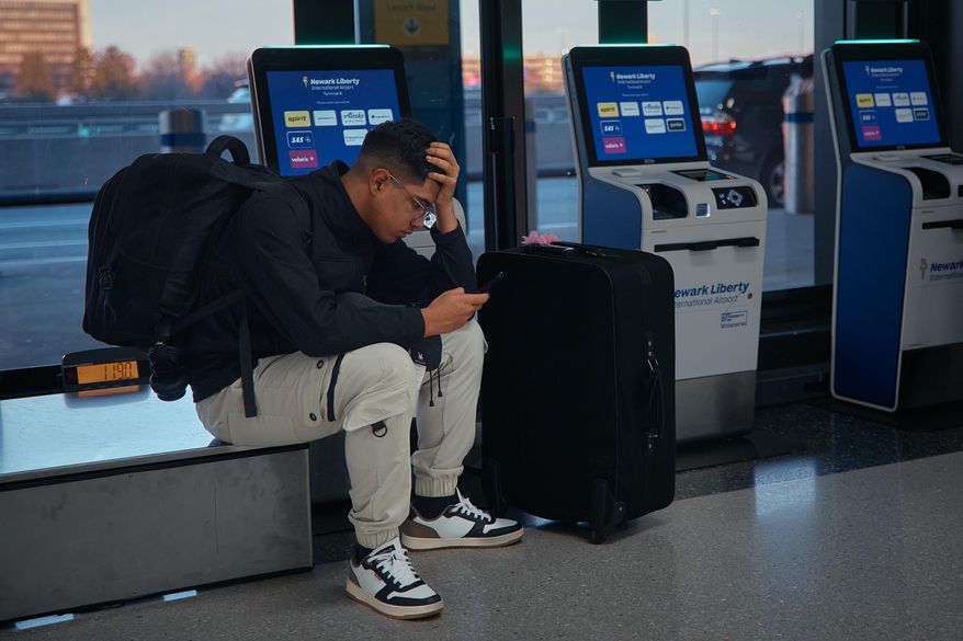 A passenger flying with Arajet to Santo Domingo waits to check in at Newark Liberty International Airport on Friday, Nov. 7, 2025 in Newark, N.J. (AP Photo/Andres Kudacki)
