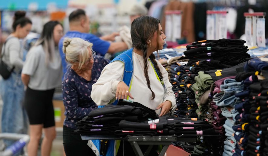 File - A worker stocks a display of clothing at a Sam's Club, Wednesday, Sept. 24, 2025, in Bentonville, Ark. (AP Photo/Charlie Riedel, File)
