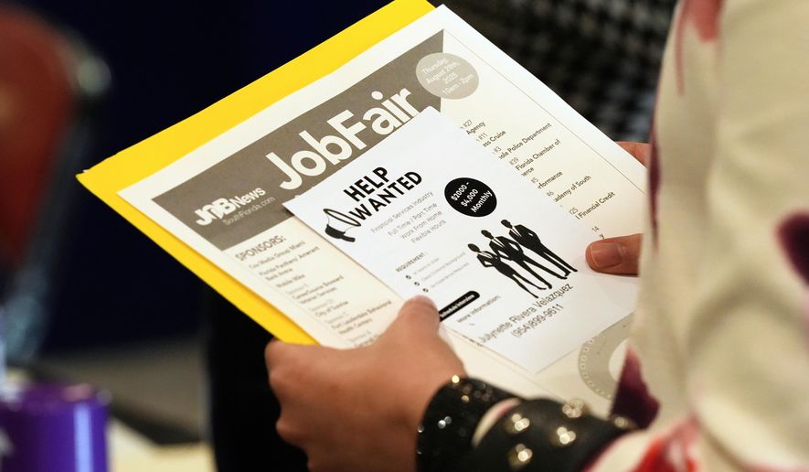FILE - A job seeker waits to talk to a recruiter at a job fair Aug. 28, 2025, in Sunrise, Fla. (AP Photo/Marta Lavandier, File)