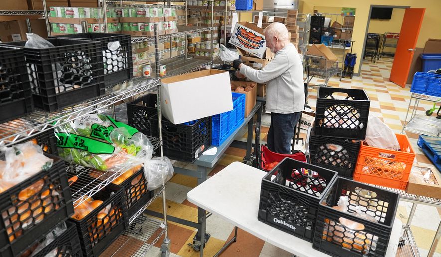 Volunteer Bruce Toben packs groceries durning an emergency food distribution at the at The Jewish Federation of Greater Philadelphia's Mitzvah Food Program in Philadelphia, Friday, Nov. 7, 2025. (AP Photo/Matt Rourke)