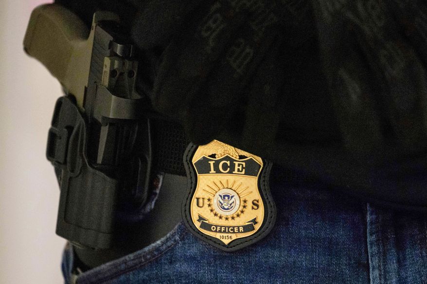 FILE - A federal agent wears an Immigration and Customs Enforcement badge at the immigration court at Jacob K. Javits Federal Building in New York, on Monday, June 9, 2025. (AP Photo/Yuki Iwamura, File)