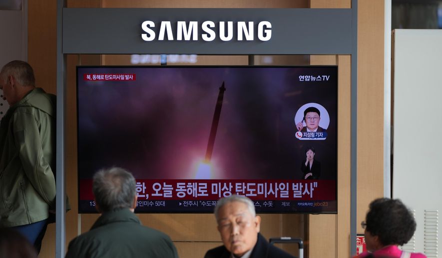 A TV screen shows a reporting of North Korea's ballistic missiles with file footage during a news program at the Seoul Railway Station in Seoul, South Korea, Friday, Nov. 7, 2025. (AP Photo/Lee Jin-man)