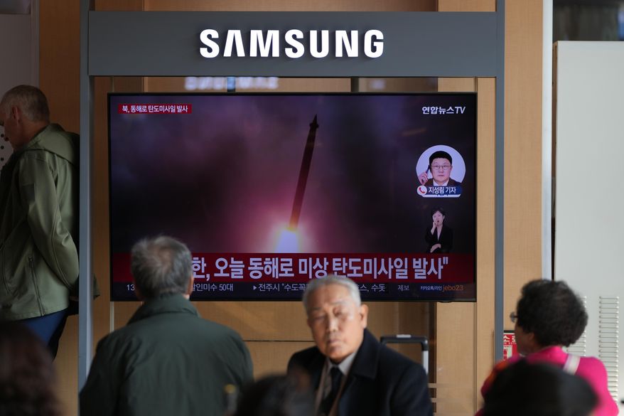 A TV screen shows a reporting of North Korea's ballistic missiles with file footage during a news program at the Seoul Railway Station in Seoul, South Korea, Friday, Nov. 7, 2025. (AP Photo/Lee Jin-man)