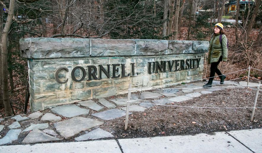 A woman walks by a Cornell University sign on the Ivy League school's campus in Ithaca, New York, on Jan. 14, 2022. (AP Photo/Ted Shaffrey) **FILE**
