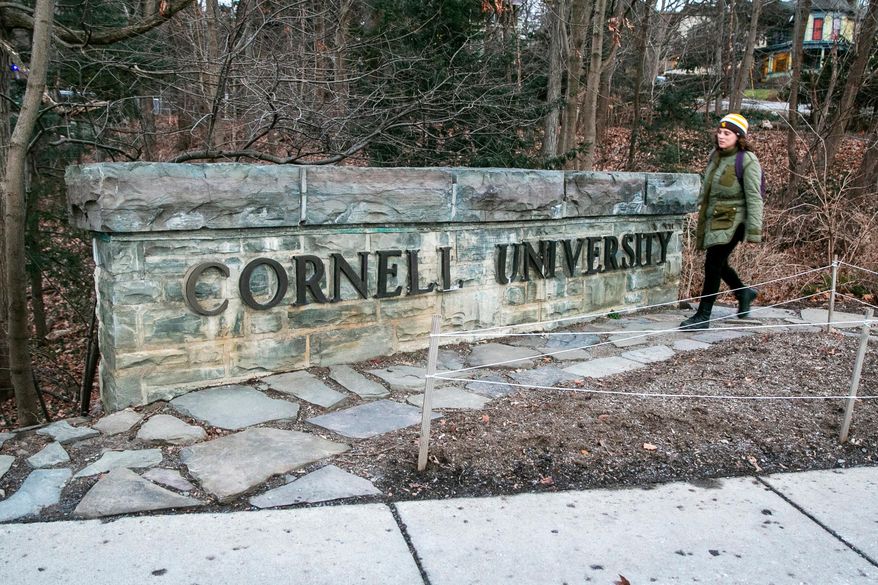 A woman walks by a Cornell University sign on the Ivy League school's campus in Ithaca, New York, on Jan. 14, 2022. (AP Photo/Ted Shaffrey) **FILE**