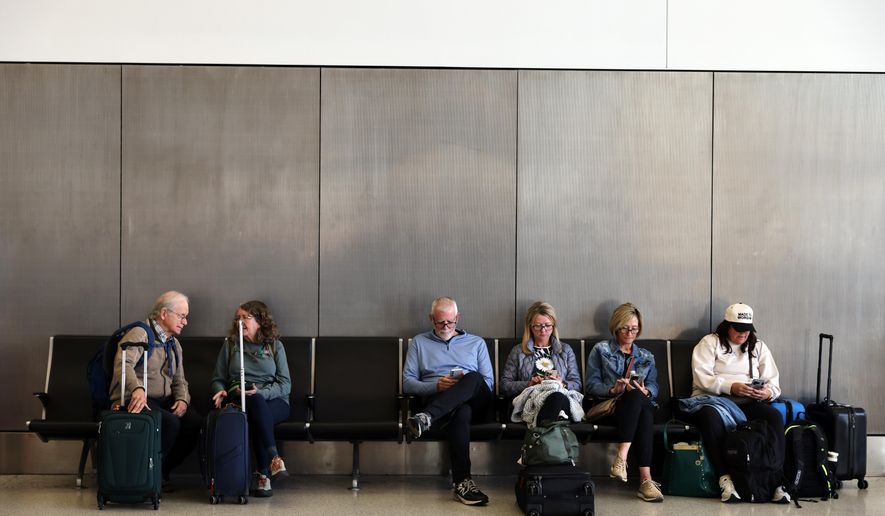 Travelers wait and check for their flights at San Francisco International Airport on Friday, Nov. 7, 2025. (Gabrielle Lurie /San Francisco Chronicle via AP)