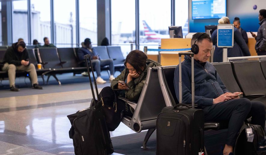 People wait for flights at Chicago O'Hare International Airport in Chicago, Ill., Sunday, Nov. 9, 2025. (AP Photo/Adam Gray)