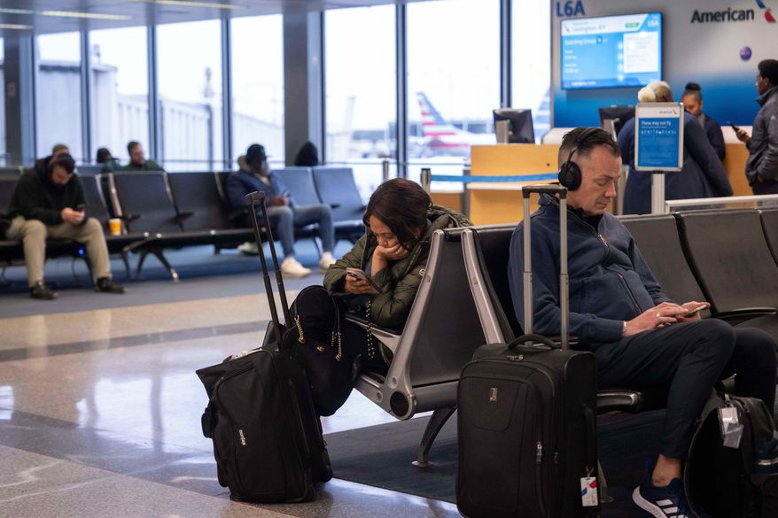 People wait for flights at Chicago O'Hare International Airport in Chicago, Ill., Sunday, Nov. 9, 2025. (AP Photo/Adam Gray)
